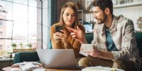 Stressful Dramatic Accounting at Home: Couple Using Laptop Compu