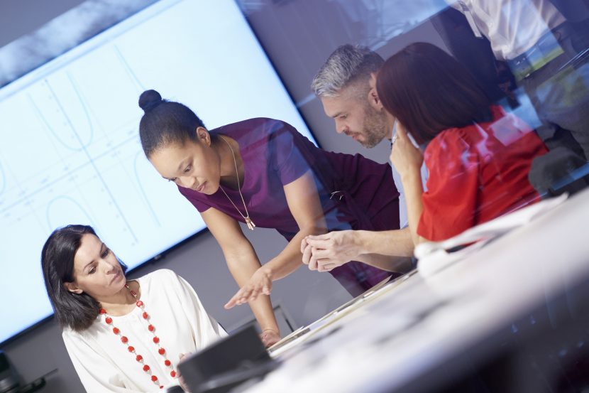 Office workers discussing in a board meeting.