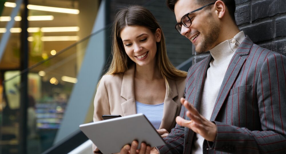 Two creative business people working on social media strategy using a digital tablet Two creative business people working on social media strategy using a digital tablet. Business people work concept