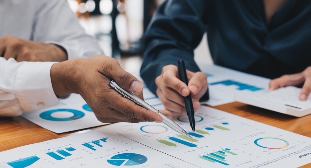 Business people meeting to analyse and discussing financial report chart data in office. Financial advisor teamwork and accounting concept